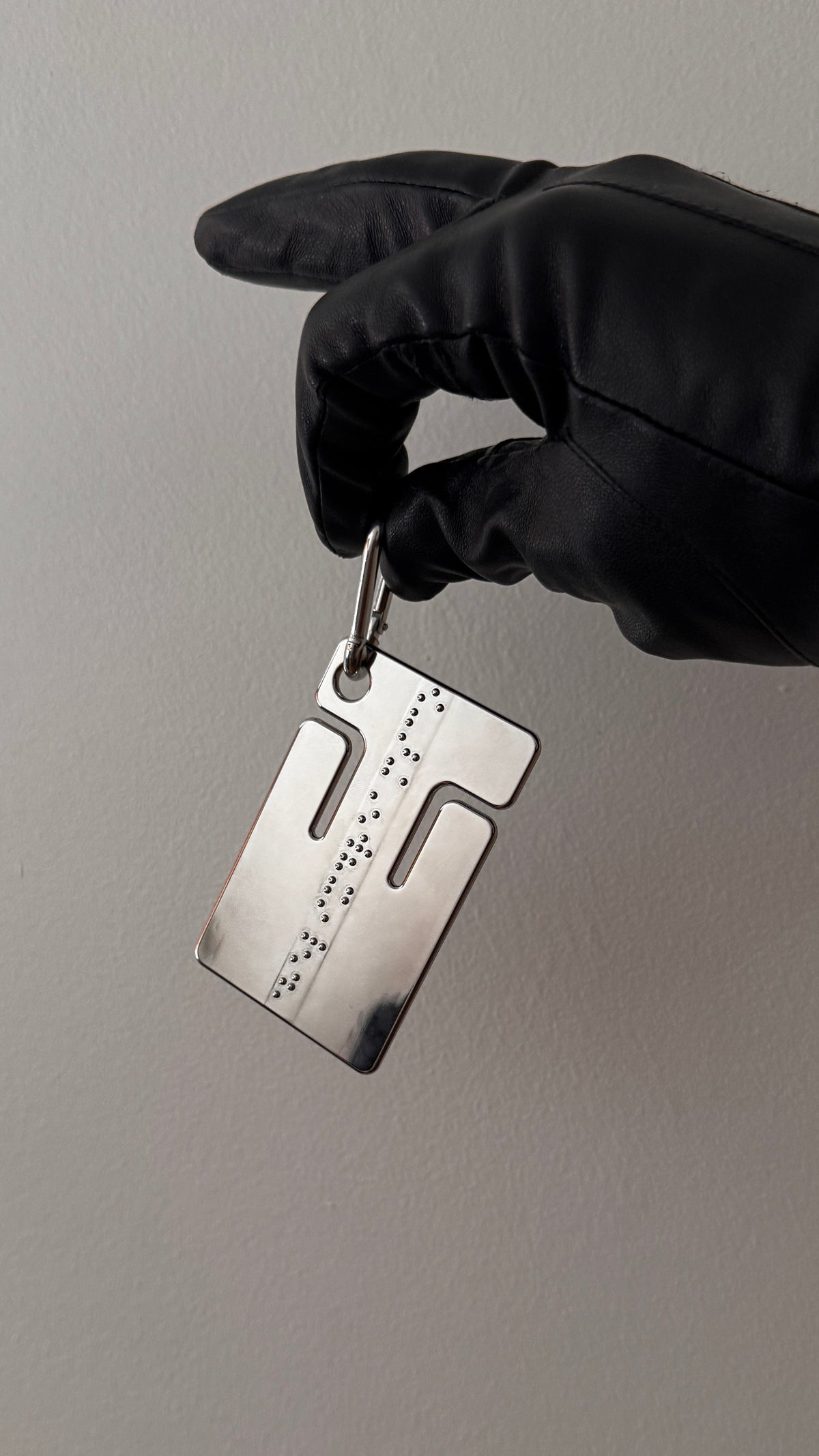cable frame chrome held in a gloved hand