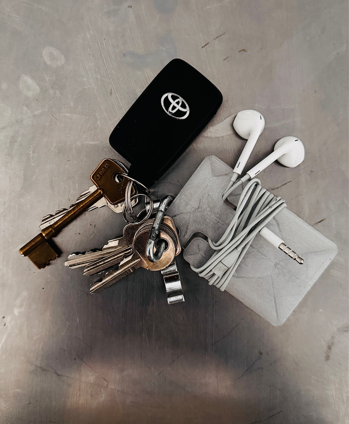 cable frame crystal with wrapped earphones next to keys