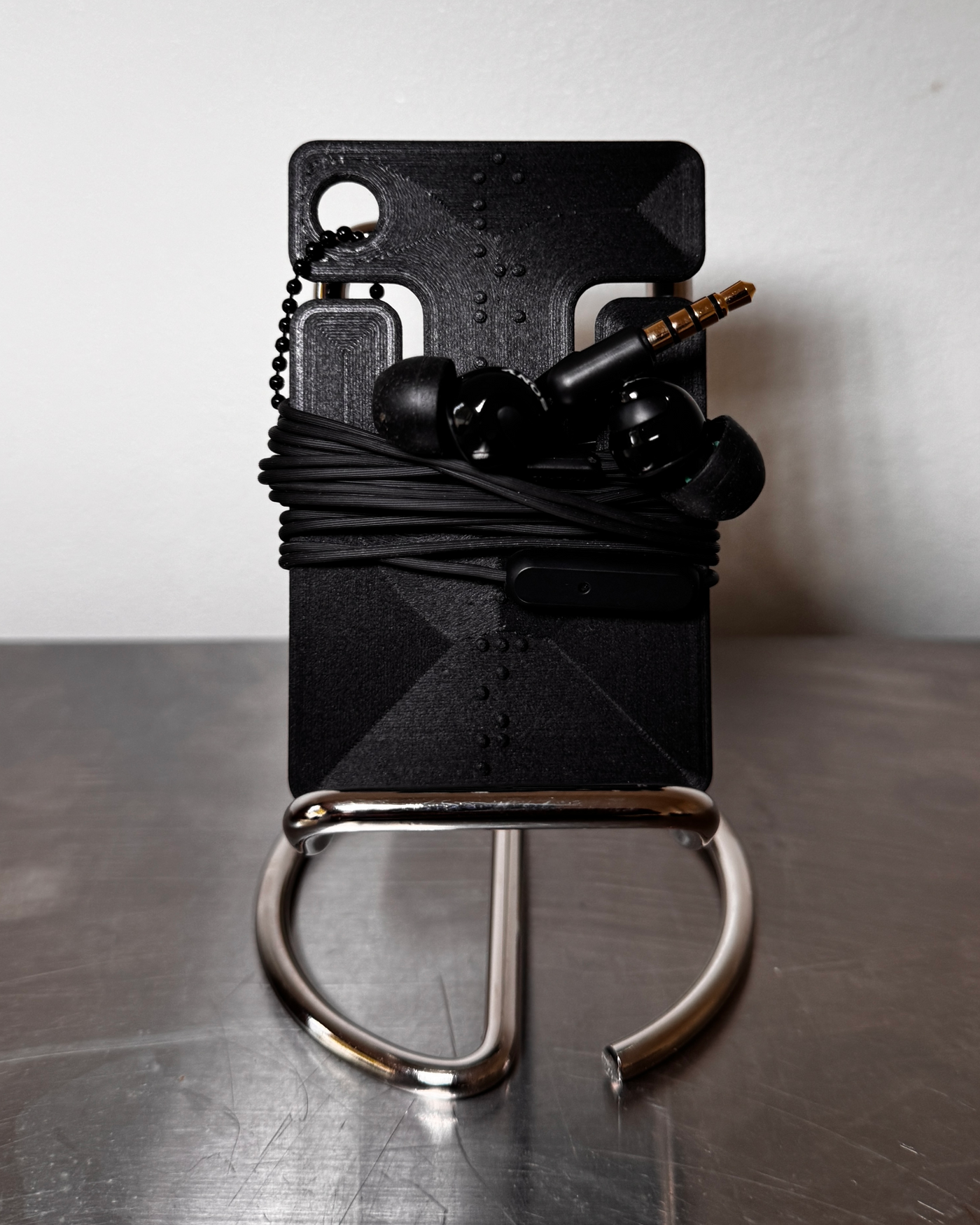 cable frame charcoal with earphones wrapped around it