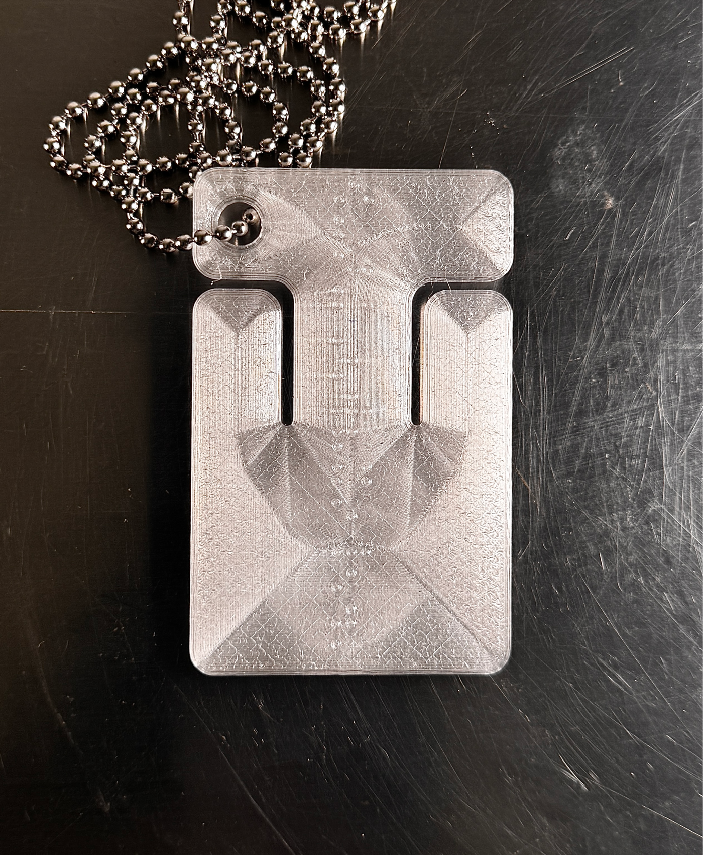 cable frame crystal — translucent faceted frame with ball chain, studio shot