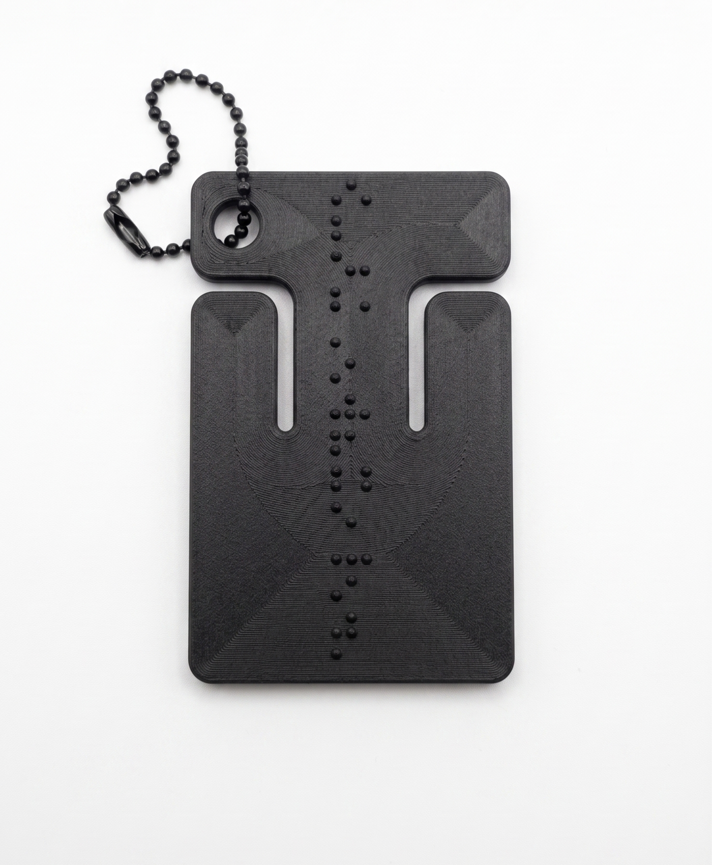 cable frame charcoal — matte black frame with braille detailing and ball chain, studio shot